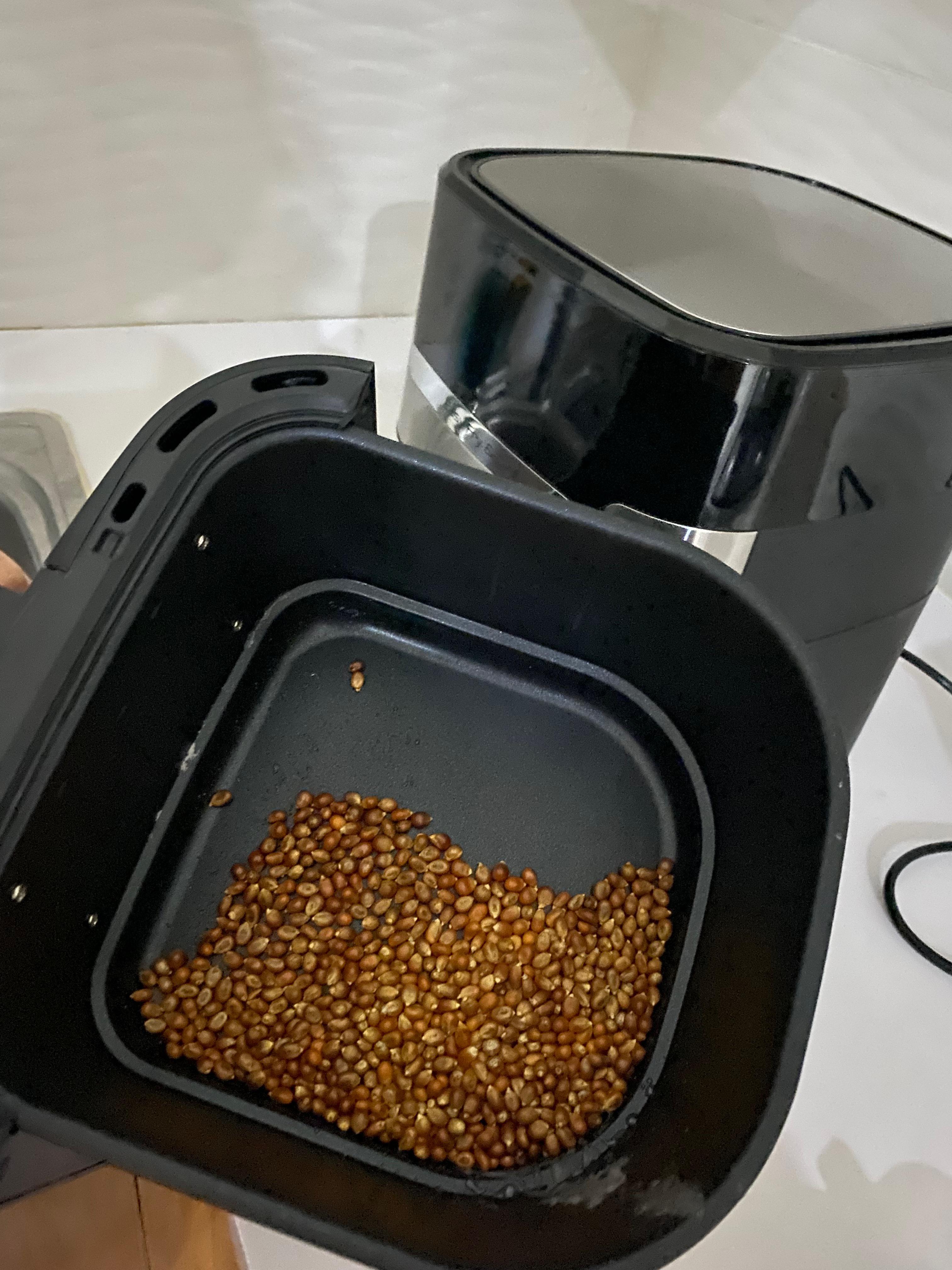 Popcorn canning machine sealing a jar of popcorn